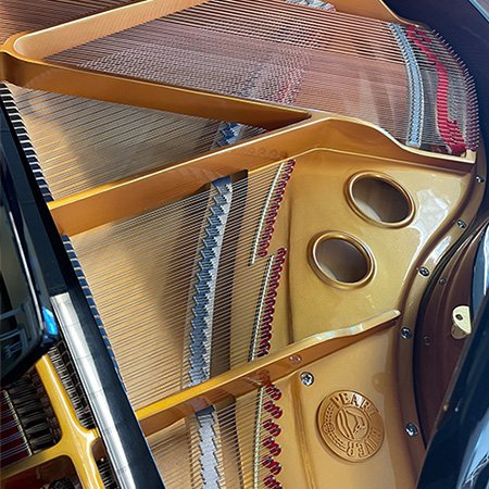 Inside frame of Pearl River piano